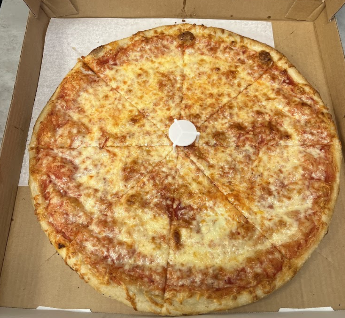 Classic cheese pizza in a box