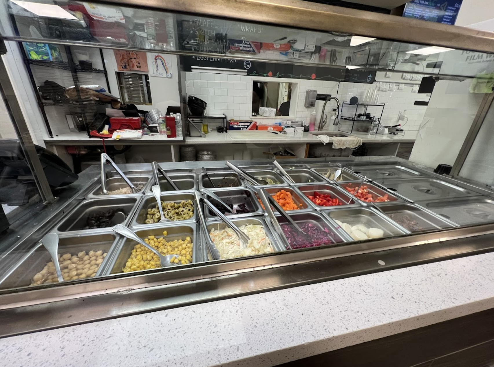 Fresh topping and salad counter at Sauly's Pizza